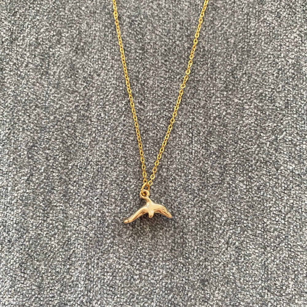 gold necklace with dolphin charm